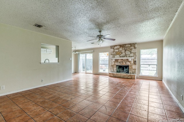14410 Briarberry, San Antonio, TX 78247 - unfurnished living room featuring ceiling fan, a textured ceiling, a stone fireplace, a textured wall, and tile patterned floors
