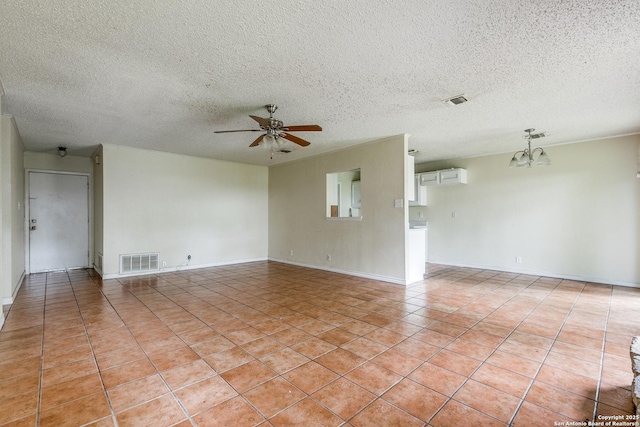 14410 Briarberry, San Antonio, TX 78247 - empty room featuring a chandelier, ceiling fan, a textured ceiling, and light tile patterned flooring