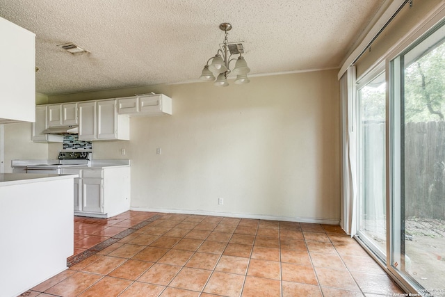 14410 Briarberry, San Antonio, TX 78247 - kitchen featuring range with electric stovetop, under cabinet range hood, light tile patterned flooring, a textured ceiling, and a chandelier