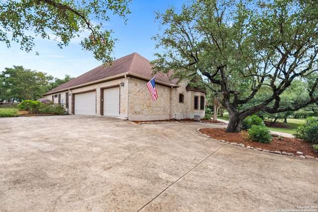 106 Oak Meadow Ln, Boerne, TX 78006 - view of property exterior with stone siding, a garage, concrete driveway, and a shingled roof