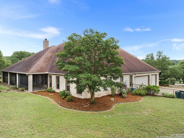 106 Oak Meadow Ln, Boerne, TX 78006 - view of property exterior featuring a sunroom, a yard, a chimney, and an attached garage