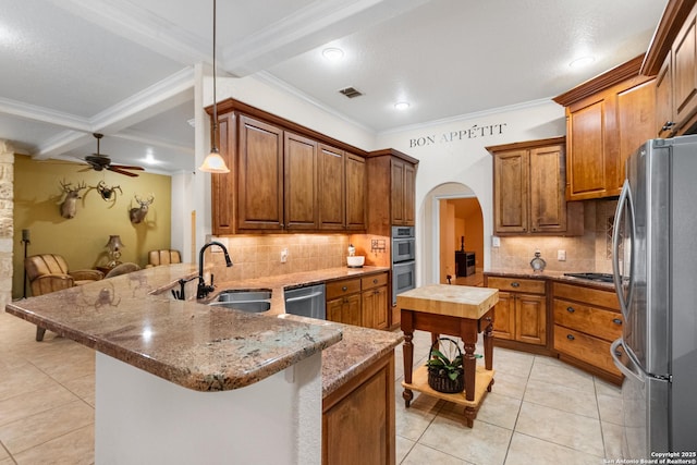 106 Oak Meadow Ln, Boerne, TX 78006 - kitchen with stainless steel appliances, light tile patterned flooring, a peninsula, ceiling fan, and arched walkways