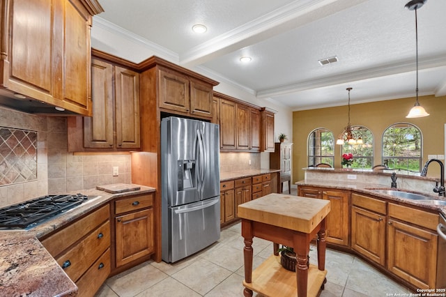 106 Oak Meadow Ln, Boerne, TX 78006 - kitchen with stainless steel appliances, brown cabinets, pendant lighting, backsplash, and crown molding