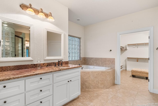 106 Oak Meadow Ln, Boerne, TX 78006 - bathroom with a garden tub, tile patterned flooring, vanity, a stall shower, and a spacious closet