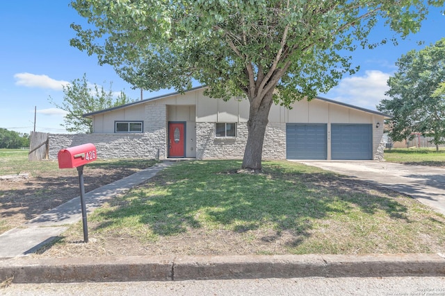 426 E Lindbergh, Universal City, TX 78148 - mid-century inspired home featuring stone siding, a garage, driveway, and a front lawn