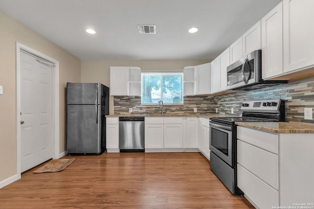 426 E Lindbergh, Universal City, TX 78148 - kitchen with stainless steel appliances, recessed lighting, open shelves, and white cabinetry