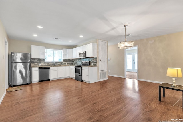 426 E Lindbergh, Universal City, TX 78148 - kitchen featuring stainless steel appliances, decorative backsplash, dark wood-style flooring, white cabinets, and recessed lighting