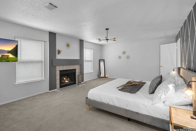 9647 Spring Harvest, San Antonio, TX 78254 - bedroom featuring a textured ceiling, carpet, and a tile fireplace