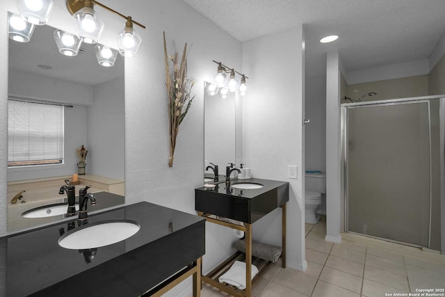 9647 Spring Harvest, San Antonio, TX 78254 - full bath featuring a shower stall, tile patterned flooring, two vanities, and a textured ceiling