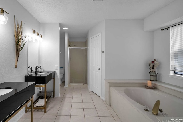 9647 Spring Harvest, San Antonio, TX 78254 - full bath with a shower stall, vanity, a garden tub, a textured ceiling, and tile patterned floors