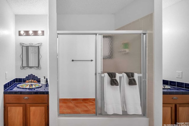 9647 Spring Harvest, San Antonio, TX 78254 - bathroom with a stall shower and a textured ceiling