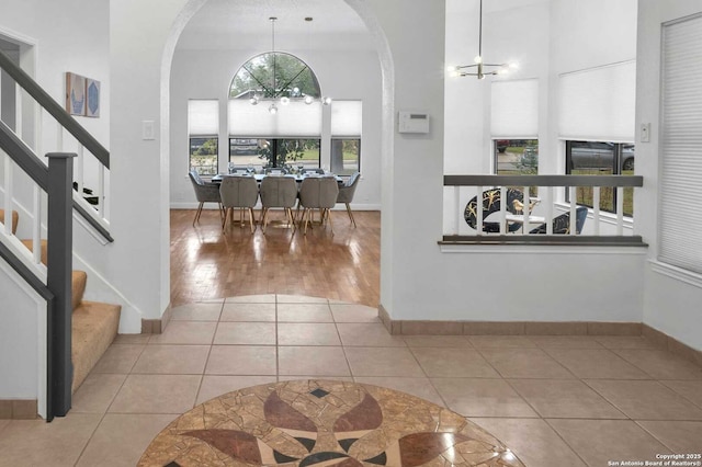 9647 Spring Harvest, San Antonio, TX 78254 - tiled entrance foyer featuring a chandelier, arched walkways, a high ceiling, and stairs