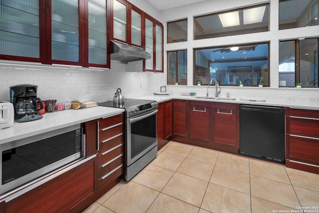 9647 Spring Harvest, San Antonio, TX 78254 - kitchen featuring stainless steel appliances, under cabinet range hood, dark brown cabinets, and decorative backsplash