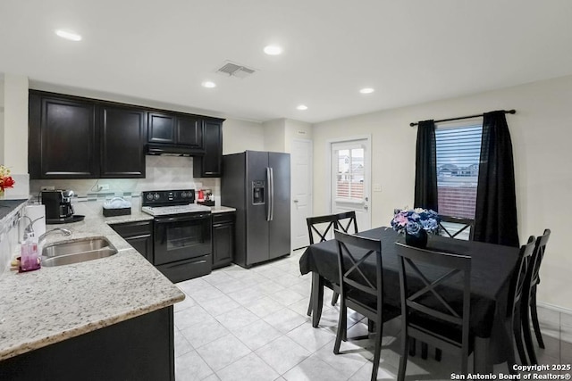 130 Texas Lantana, New Braunfels, TX 78130 - kitchen featuring black range with electric cooktop, fridge with ice dispenser, decorative backsplash, dark cabinets, and light stone counters