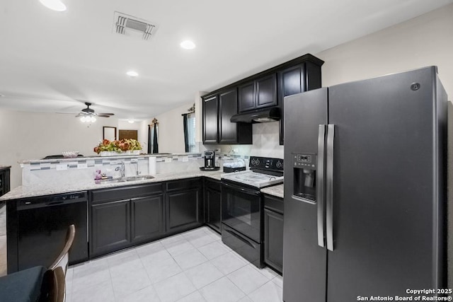 130 Texas Lantana, New Braunfels, TX 78130 - kitchen with black appliances, under cabinet range hood, a peninsula, a ceiling fan, and light stone counters