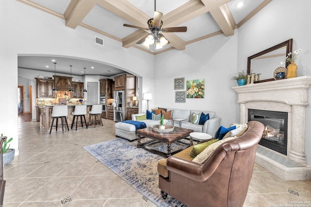 27306 Dana Crk, Boerne, TX 78015 - living area featuring coffered ceiling, arched walkways, a ceiling fan, a high end fireplace, and light tile patterned floors