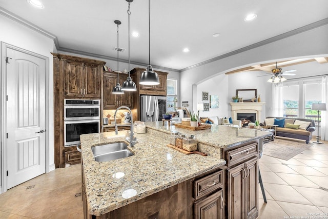 27306 Dana Crk, Boerne, TX 78015 - kitchen featuring a fireplace, stainless steel appliances, a ceiling fan, crown molding, and light tile patterned floors