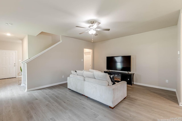 13609 Mineral Wl, San Antonio, TX 78253 - living room with ceiling fan, light wood-style floors, and stairway