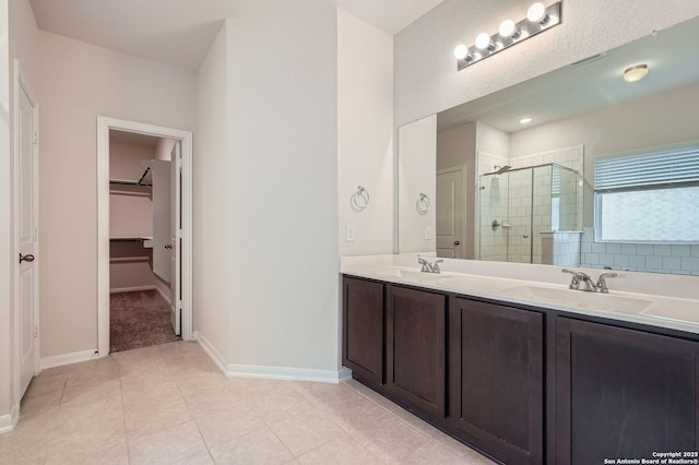 8904 Portobello Way, Converse, TX 78109 - full bathroom featuring a shower stall, a spacious closet, double vanity, and tile patterned floors