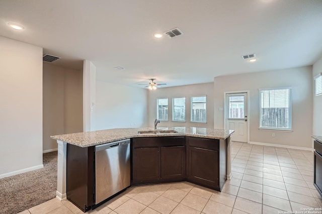 8904 Portobello Way, Converse, TX 78109 - kitchen with dishwasher, dark brown cabinetry, ceiling fan, light tile patterned floors, and light stone counters