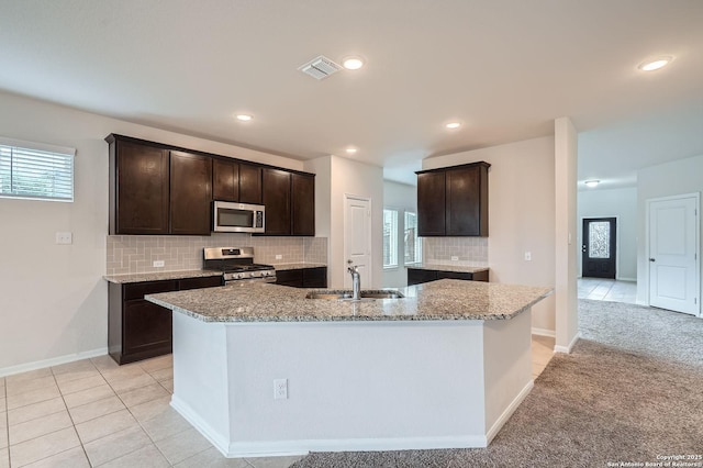 8904 Portobello Way, Converse, TX 78109 - kitchen with appliances with stainless steel finishes, dark brown cabinets, tasteful backsplash, plenty of natural light, and recessed lighting
