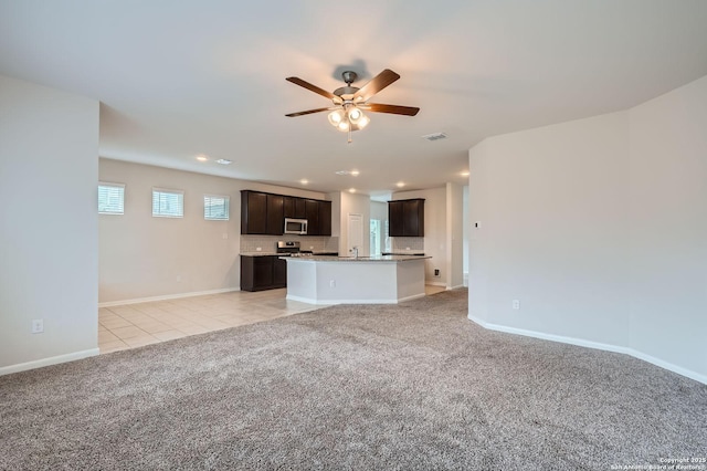 8904 Portobello Way, Converse, TX 78109 - unfurnished living room with light colored carpet, a ceiling fan, recessed lighting, and light tile patterned floors