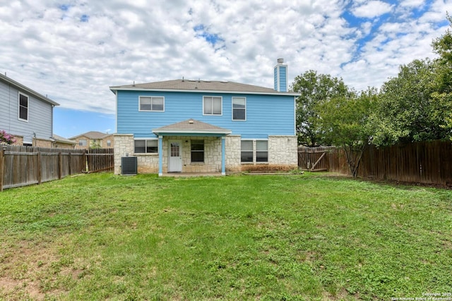 11906 Creek Peak, San Antonio, TX 78253 - back of house featuring a chimney, stone siding, a fenced backyard, and a patio area
