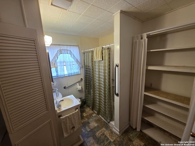 115 Dumont, San Antonio, TX 78227 - full bathroom featuring a shower with curtain, vanity, and stone finish floors