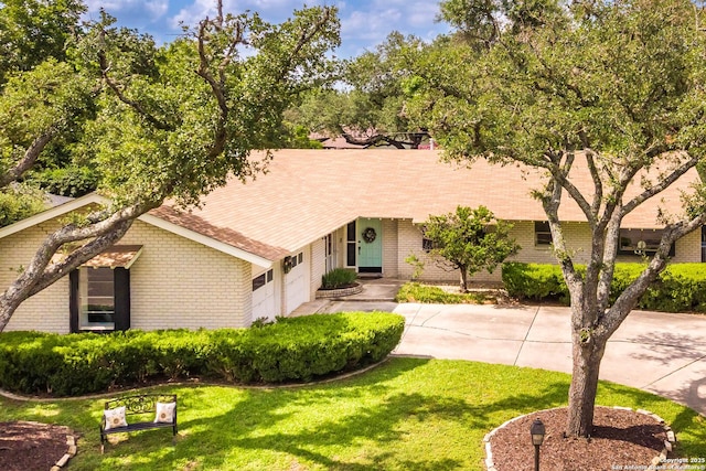505 Winfield Blvd, Windcrest, TX 78239 - ranch-style house with brick siding, a garage, a front lawn, and concrete driveway