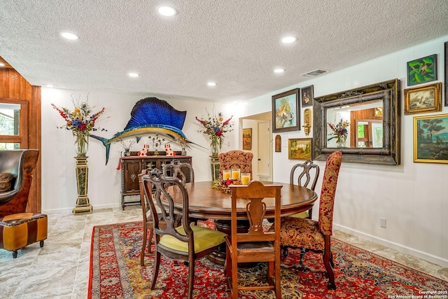 505 Winfield Blvd, Windcrest, TX 78239 - dining area with a textured ceiling, recessed lighting, and wooden walls
