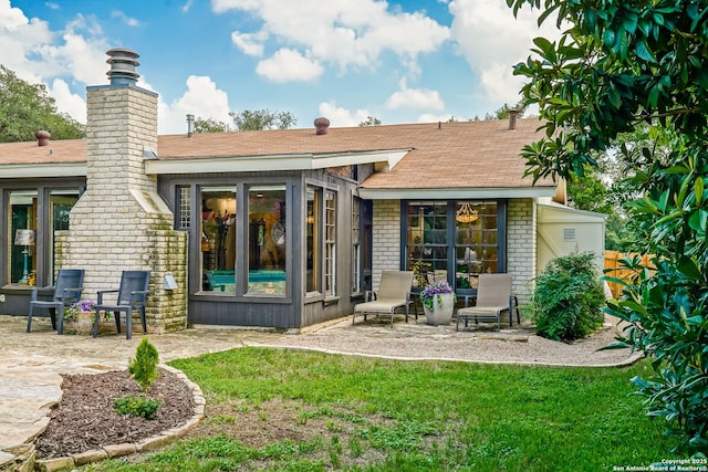 505 Winfield Blvd, Windcrest, TX 78239 - back of house featuring a patio area, a chimney, brick siding, and roof with shingles