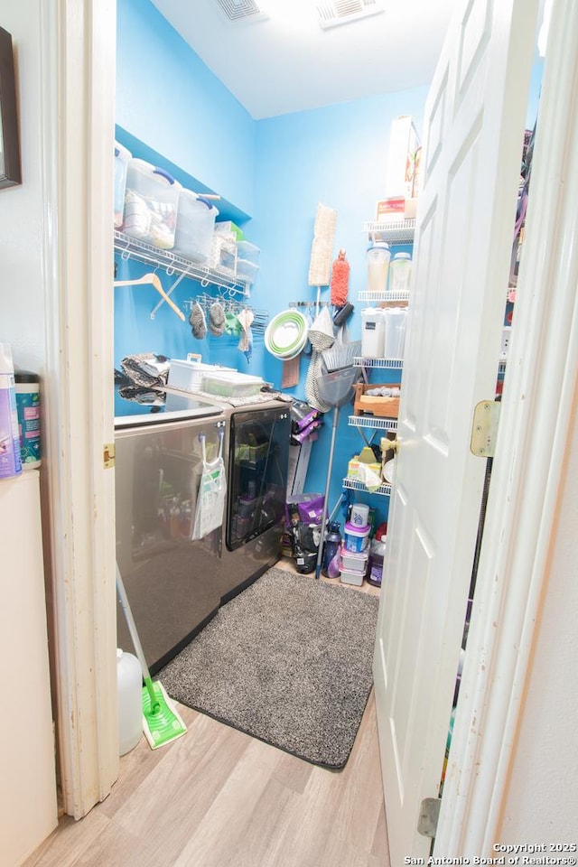 9075-1 W Foxgrove Way, San Antonio, TX 78251 - laundry area with washer and dryer and wood finished floors