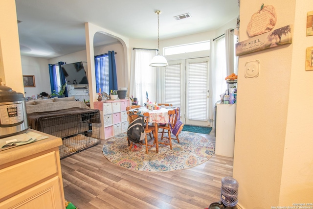9075-1 W Foxgrove Way, San Antonio, TX 78251 - dining space featuring wood finished floors and arched walkways