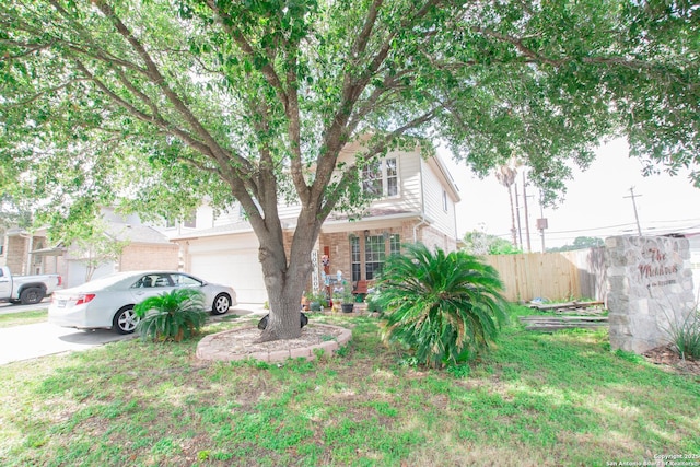 9075-1 W Foxgrove Way, San Antonio, TX 78251 - view of property hidden behind natural elements with brick siding, an attached garage, and driveway