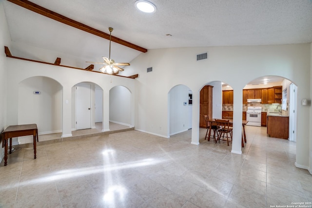 2814 Rim Rock, San Antonio, TX 78251 - unfurnished room featuring ceiling fan, beam ceiling, arched walkways, high vaulted ceiling, and light tile patterned floors