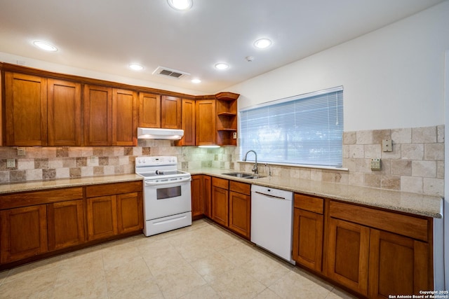 2814 Rim Rock, San Antonio, TX 78251 - kitchen with white appliances, under cabinet range hood, brown cabinets, open shelves, and recessed lighting