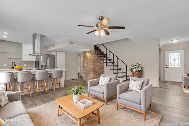 11115 Rendezvous, San Antonio, TX 78216 - living room featuring stairs, light wood finished floors, and ceiling fan