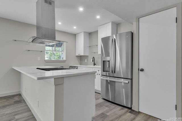 11115 Rendezvous, San Antonio, TX 78216 - kitchen with stainless steel refrigerator with ice dispenser, island exhaust hood, light wood-style floors, white cabinetry, and recessed lighting
