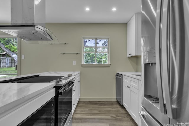 11115 Rendezvous, San Antonio, TX 78216 - kitchen featuring appliances with stainless steel finishes, island exhaust hood, wood finished floors, recessed lighting, and white cabinets