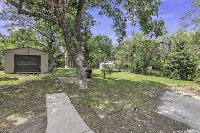 11115 Rendezvous, San Antonio, TX 78216 - view of grassy yard with a storage unit and view of scattered trees