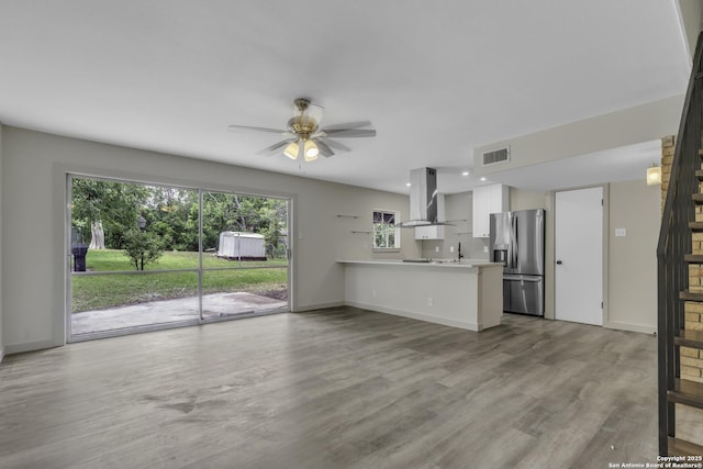 11115 Rendezvous, San Antonio, TX 78216 - unfurnished living room with a ceiling fan, wood finished floors, and recessed lighting