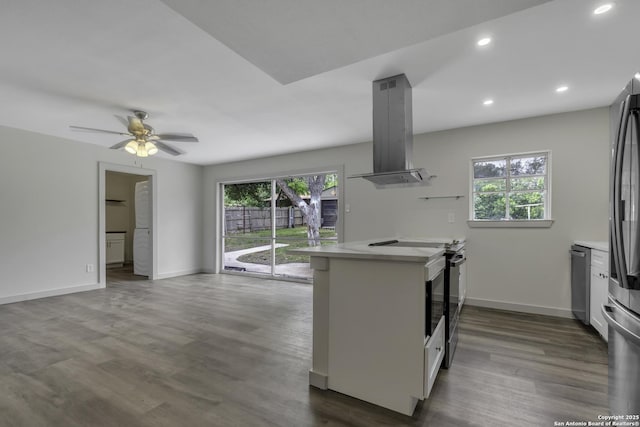 11115 Rendezvous, San Antonio, TX 78216 - kitchen with island exhaust hood, light countertops, stainless steel appliances, dark wood-style floors, and healthy amount of natural light