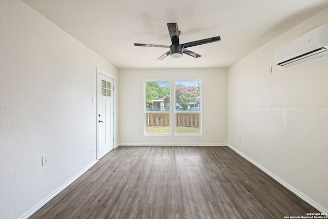 211 Sylvia, San Antonio, TX 78237 - spare room featuring a wall mounted AC, dark wood-type flooring, and a ceiling fan