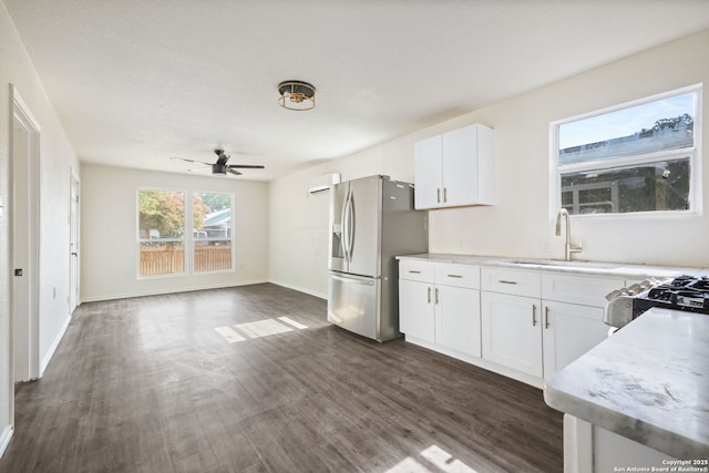 211 Sylvia, San Antonio, TX 78237 - kitchen with stainless steel fridge with ice dispenser, ceiling fan, dark wood-style flooring, and white cabinets