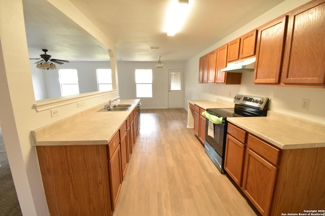1510 June Berry, San Antonio, TX 78260 - kitchen featuring stainless steel electric range, under cabinet range hood, light wood finished floors, light countertops, and a ceiling fan