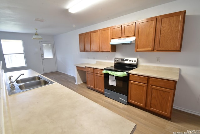 1510 June Berry, San Antonio, TX 78260 - kitchen with electric stove, under cabinet range hood, light wood-type flooring, and light countertops
