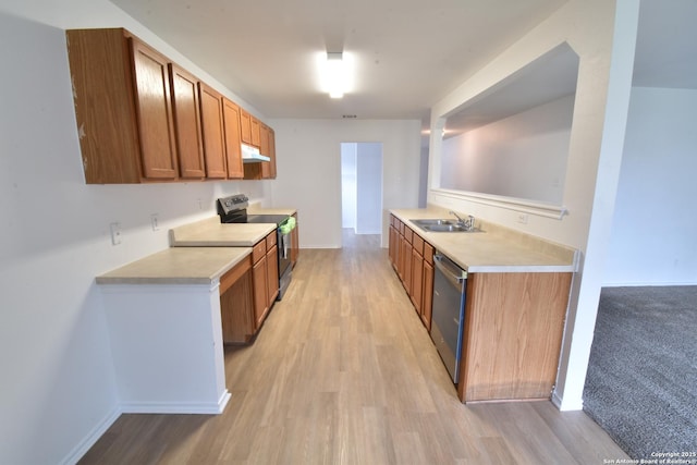 1510 June Berry, San Antonio, TX 78260 - kitchen with appliances with stainless steel finishes, light countertops, under cabinet range hood, light wood-style floors, and brown cabinetry