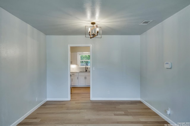 8302 Hastings, San Antonio, TX 78239 - spare room with a chandelier and light wood-style flooring