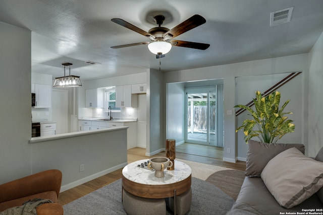 8302 Hastings, San Antonio, TX 78239 - living room with light wood finished floors, plenty of natural light, and ceiling fan