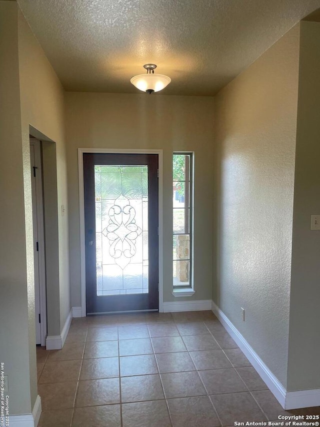812 33rd St, Hondo, TX 78861 - foyer entrance featuring a textured ceiling, tile patterned flooring, and a textured wall